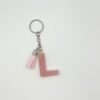 Porte clé lettre L rose avec paillettes dorées