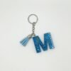 Porte clé lettre M bleu avec paillettes